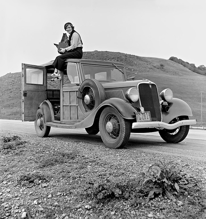 726px Dorothea Lange atop automobile in California