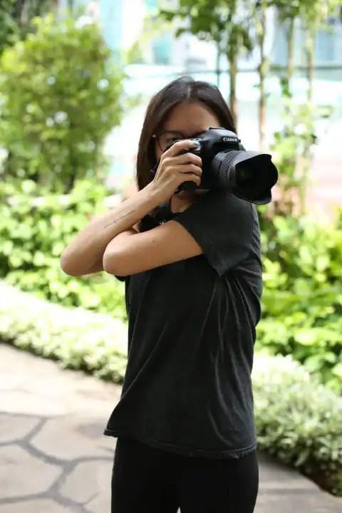 Confident black female in a white shirt exuberant pose reaching to the  camera with a hand Stock Photo by wirestock